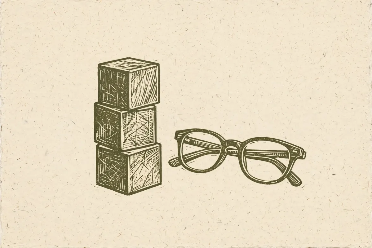 Woodcut-style illustration: a small wooden toy block stack next to a pair of adult reading glasses